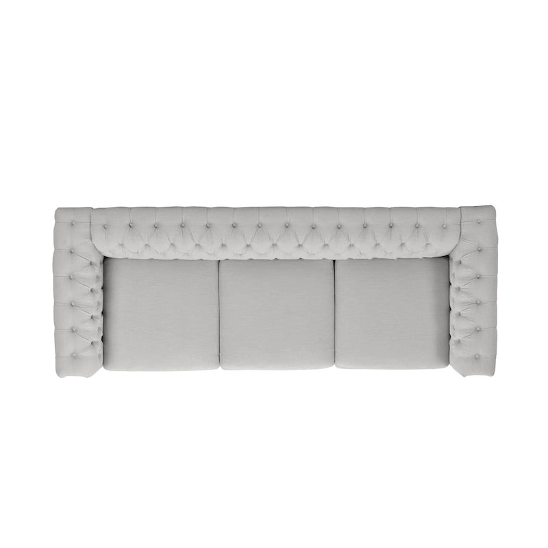 Szara sofa Chesterfield z pikowaniem w guziki